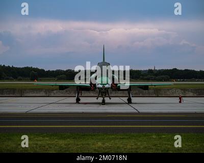 Modern green-white military training jet parking at an airfield after mission, Saudi Air Force, frontal view, cloudy sunset behind, Kecskemet airshow Stock Photo
