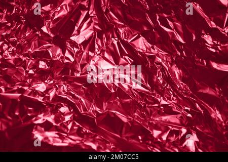 Texture foil Viva Magenta color. Background for your design. Crumpled colored Viva Magenta foil. Stock Photo