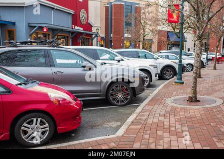 Cars parked in row on outdoor parking in a town. Cars parked in line on the roadside in Vancouver BC Canada-December 1,2022. Street photo, nobody, blu Stock Photo