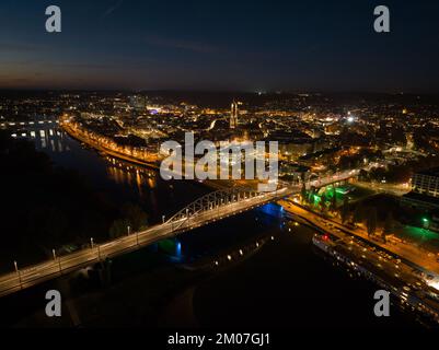 Arnhem city in the Netherlands by night Aerial drone. City center, rhine river and church, Eusebiuskerk, john frost bridge, skyline and infrastructure Stock Photo