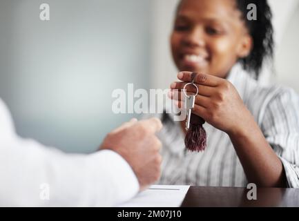 Enjoy your stay, sir. Closeup of a receptionist handing over the hotel room keys to a senior patron. Stock Photo