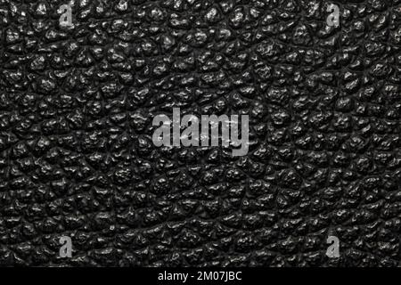 Dark black bumpy textured background image with highlights. Rough leather or animal skin appearance. Stock Photo