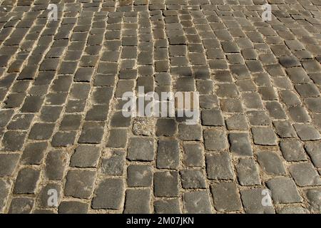 Stone pavement texture. Granite cobblestoned pavement background. Abstract background of old cobblestone pavement close-up. Seamless texture. Stock Photo