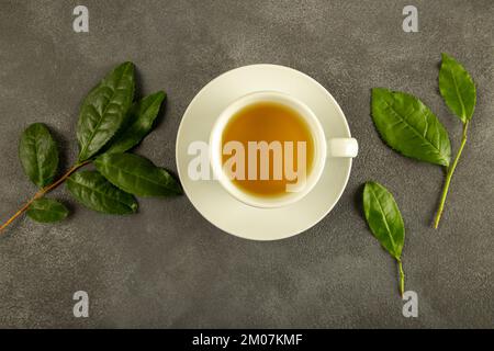 Tea leaves with a cup of green tea,on black backgrou Stock Photo