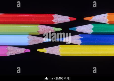 Colorful pencils against a black background Stock Photo