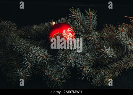 Christmas New Year decoration composition. Top view of fur-tree branches and balls frame on wooden background with place for your text. close up Stock Photo