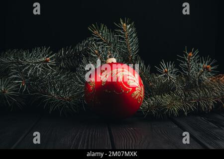 Christmas New Year decoration composition. Top view of fur-tree branches and balls frame on wooden background with place for your text. close up Stock Photo