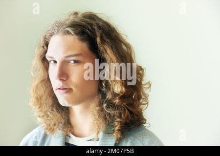 Hes got hidden depths. Portrait of a casual young man with long, curly hair. Stock Photo
