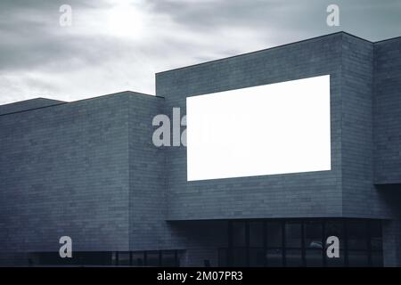 Blank white horizontal billboard sign mockup on building facade, empty space to display advertising or public information Stock Photo