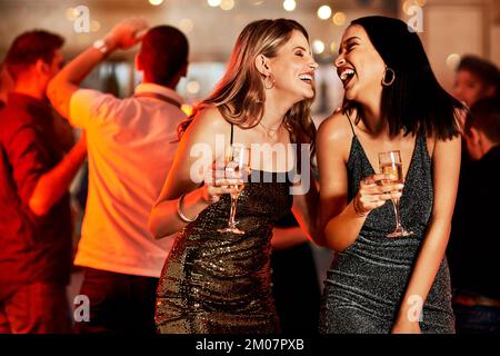 Women, laughing or bonding in champagne night party, clubbing event or birthday celebration in New York. Smile, happy people or friends with alcohol Stock Photo