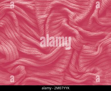 Texture of smooth knitted sweater with pattern. Color Of The Year 2023 - Viva Magenta Stock Photo