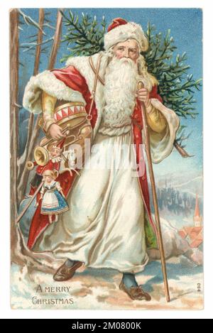 Original charming and very classic Victorian Christmas card or Edwardian period Christmas card of a traditional Victorian Father Christmas, Victorian Santa Claus, carrying a Christmas tree and old fashioned children's toys, with the message 'A Merry Christmas' U.K. Victorian Christmas card. Circa 1907 Stock Photo