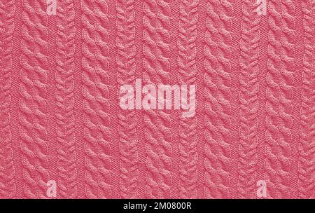 Texture of smooth knitted sweater with pattern. Color Of The Year 2023 - Viva Magenta Stock Photo