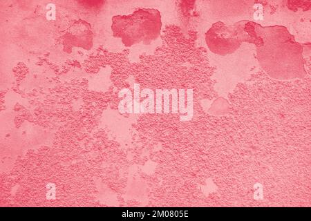 Background of peeling Magenta paint on an old textured wall. Color Of The Year 2023 - Viva Magenta. Stock Photo