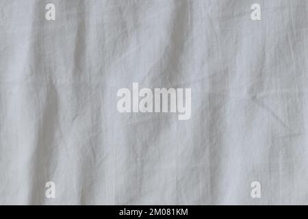 Wrinkled white bed sheets in the bedroom as background, top view Stock Photo