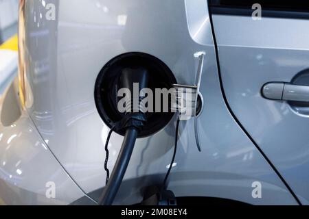 A type 2 electrical cable connected to the charging socket of an electric car with the Wallbox. Concept for the trendy lifestyle of refueling your car Stock Photo