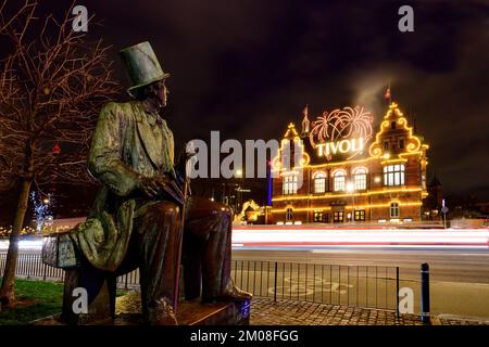 Copenhagen, Denmark; December 4, 2022 - A statue of H.C Andersen looks across to the Tivoli Gardens in Copenhagen, Denmark Stock Photo
