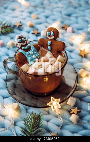 Concept of couples spa Christmas holiday. Couple woman and a man made out of an gingerbread that soak in cup of hot chocolate with marshmallows, cozy.