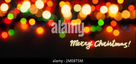 Merry Christmas - Handwritten Text and Defocused Lights In The Background Stock Photo