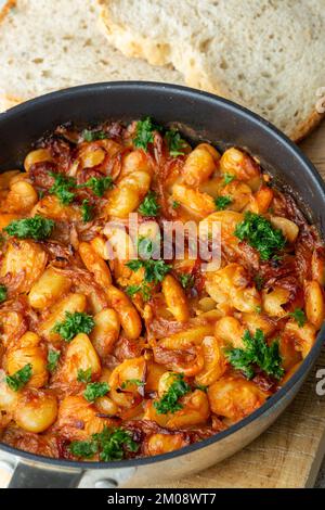 Prebranac a traditional Serbian dish of slow-cooked butter beans with caramelised onions Stock Photo