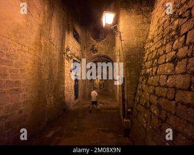 Boy in an alley in the old town of Kotor, historical, night, eerie, Bay of Kotor, Adriatic Sea, Mediterranean Sea, World Natural and Cultural Heritage Stock Photo