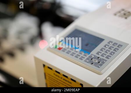 Control panel of laser cutter engraving machine. Selective focus. Stock Photo