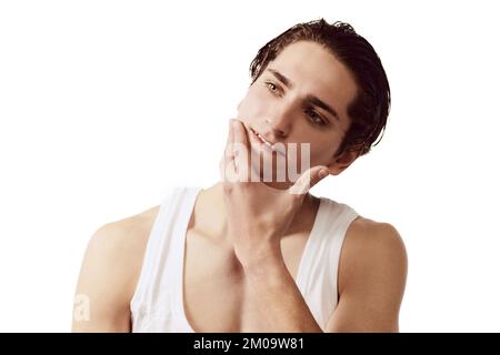 Portrait of young man after face shaving isolated over white background. Face cosmetics. Concept of male beauty, body and skincare Stock Photo