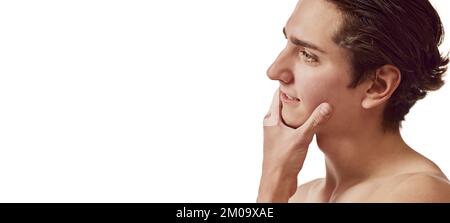 Portrait of young man after shaving isolated over white background. Men's face cosmetics. Concept of male beauty, body and skincare. Flyer Stock Photo