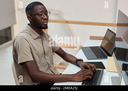 Serious Black programmer developing software updates side view Stock Photo