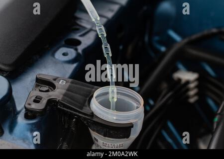 Blue cap of the tank for windshield washer fluid, close up Stock Photo -  Alamy