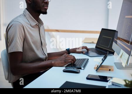 Cropped image of developer writing programming code to automate process Stock Photo