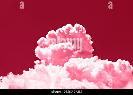 Large cumulus cloud on clear pink sky. Concept of environmental pollution. Image toned in color of the year 2023 viva magenta. Stock Photo