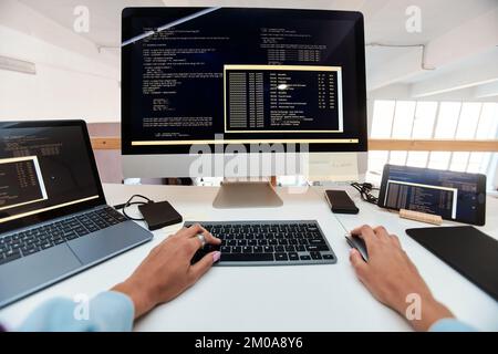 First person view of female software developer coding on computer Stock Photo