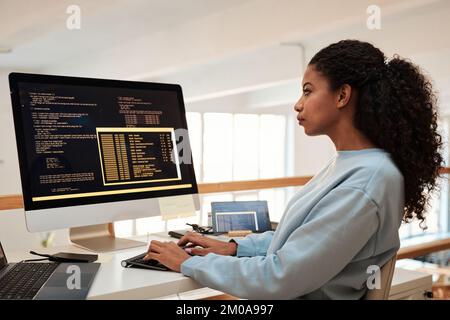Young female software engineer verifying and deploying programs and systems Stock Photo