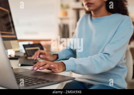 Cropped image of software developer working on laptop in modern office Stock Photo