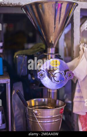 Ho Chi Minh City, Vietnam - November 10, 2022: Inside Ben Thanh Market at Saigon District 1. Vietnamese coffee grinder in a coffee shop. Vietnamese co Stock Photo