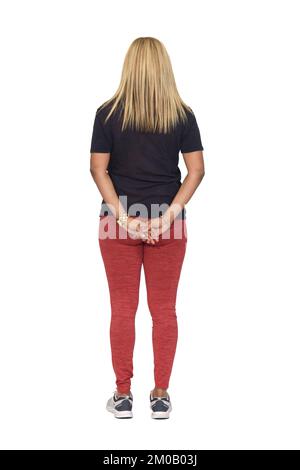rear view of a woman in sportswear with her hands crossed behind her back on white background Stock Photo