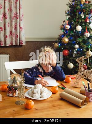 Kid writing letter to Santa Clause. Stock Photo