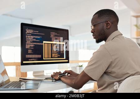 Serious programmer working on ways to automate and release processes Stock Photo