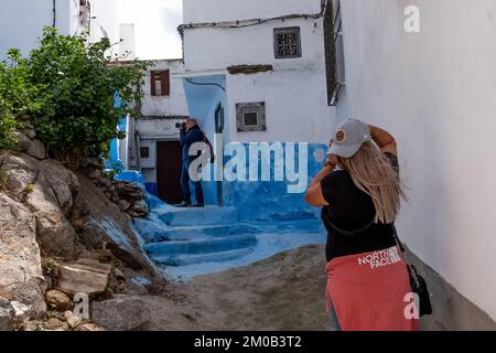 Tetouan, Morocco - April 19, 2019: Tourists visiting the streets of Tetuan, photographing the narrow and picturesque streets Stock Photo