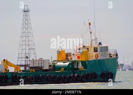 Cabimas-Zulia-Venezuela- 29-11-2007-A tugboat of oil tnakers passes in front to oil tower in Lake Maracaibo. © JOSE ISAAC BULA URRUTIA Stock Photo