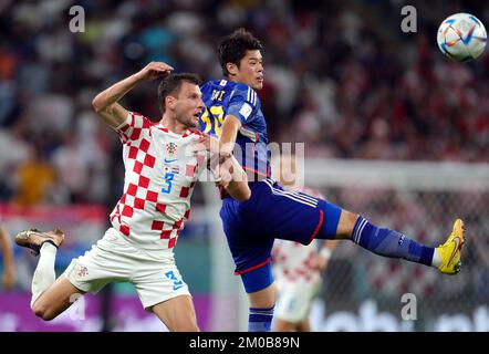 Croatia's Borna Barisic (left) and Japan’s Hiroki Sakai battle for the ball during the FIFA World Cup Round of Sixteen match at the Al Janoub Stadium in Al-Wakrah, Qatar. Picture date: Monday December 5, 2022. Stock Photo