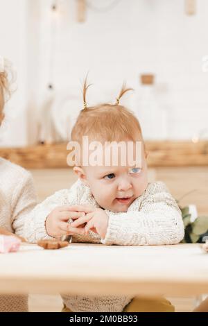little girl with two ponytails shows funny faces with anger Stock Photo