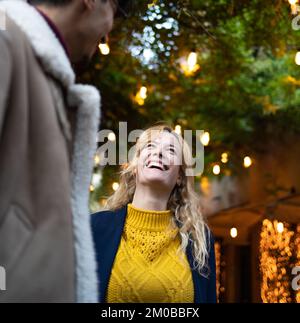 selective focus on smiling blonde woman talking with a friend Stock Photo