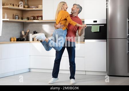Loving mature man and woman enjoying time together at home Stock Photo