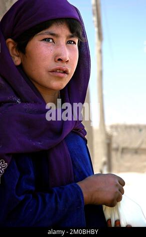Ghazni / Afghanistan: A local Afghan girl in the old city of Ghazni in central Afghanistan. The girl wears traditional clothes. Stock Photo