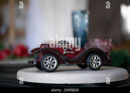 wooden vintage car model on a white stand. Stock Photo