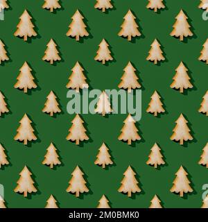 Large and small wooden fir tree silhouettes over green background. Christmas and New Year seamless pattern. Winter holidays design element. Stock Photo