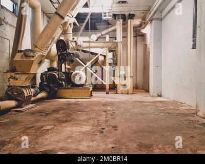 An interior shot of an old corn production machinery in a factory Stock Photo