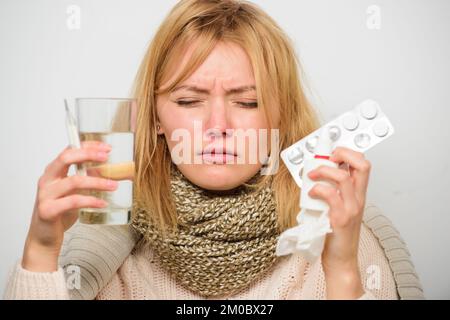 Getting fast relief. Ways to feel better fast. Headache and flu remedies. Get rid of flu. Woman wear warm scarf because illness or flu. Girl hold Stock Photo